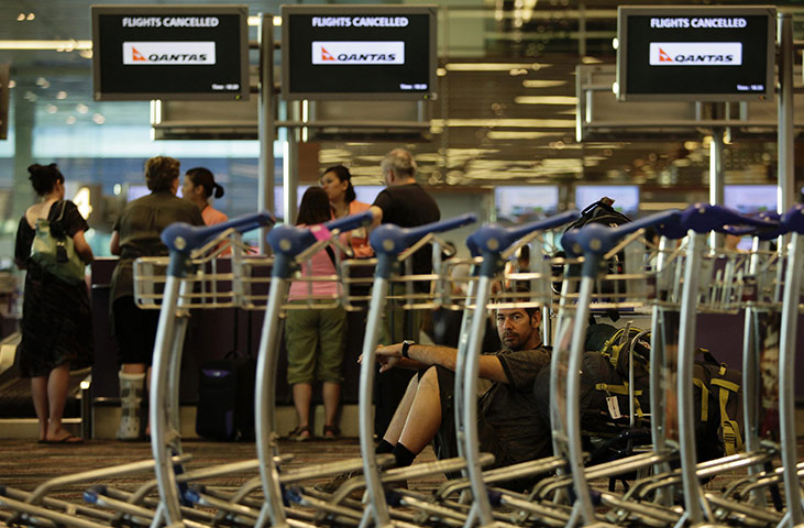 Qantas dispute: Stranded Qantas passengers wait at Singapore's Changi Airport