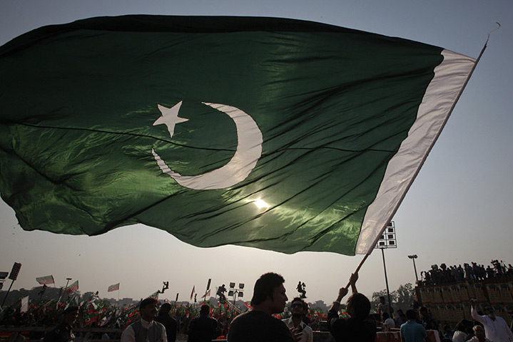 24 hours: Lahore, Pakistan: A man waves a flag during an anti-government rally 