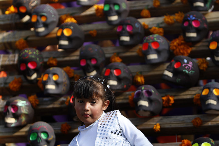 Halloween: Mexico City, Mexico: A girl poses in front of candy skulls