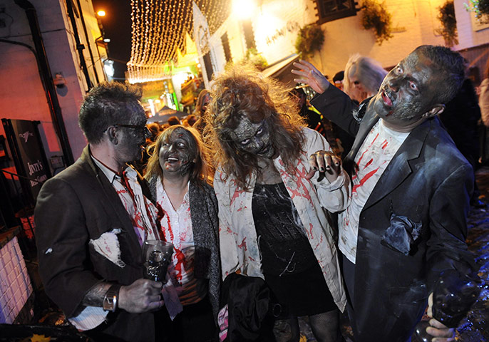 Halloween: Glasgow, UK: Party goers at the Creatures of the Night street party