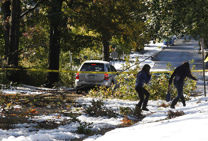 New York state snowstorm: Girls walk around downed powerlines and fallen branches in Larchmont