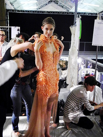 McQueen: dressers fastening the tiny buttons