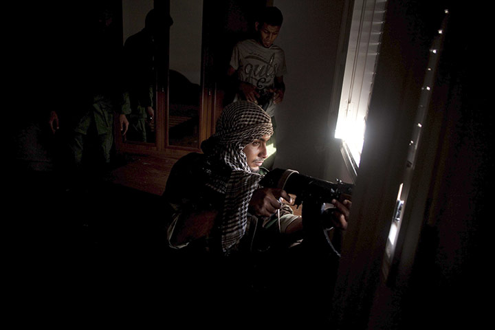 24 hours in pictures: Sirte, Libya: A revolutionary sniper scans for targets