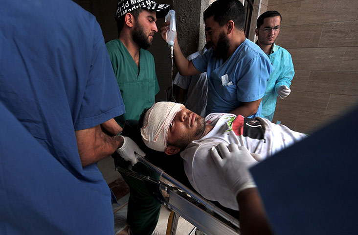The battle for Sirte: Medical experts carry a wounded Libyan NTC fighter