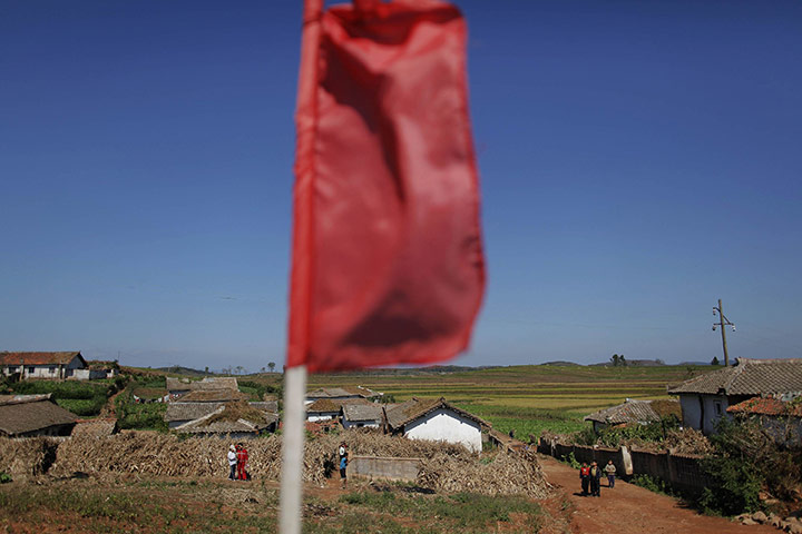 Famine in North Korea: North Korean children are seen under a red flag