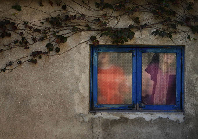 Famine in North Korea: North Korean girls look through a window 