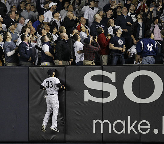Best of the week in Sport: New York Yankees' Nick Swisher watches Detroit Tigers' Don Kelly's home run