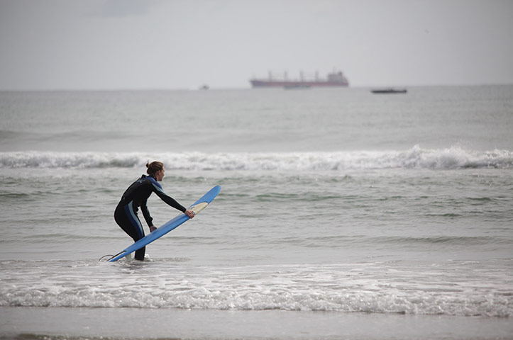New Zealand oil spill: A surfer near the Port of Tauranga  New Zealand
