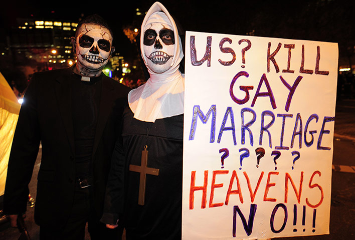 New York Halloween parade: A couple carries a placard supporting same sex marriage
