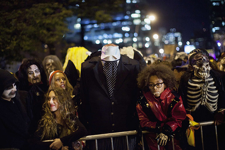 New York Halloween parade: A crowd of people dressed in Halloween costumes wait to start the parade