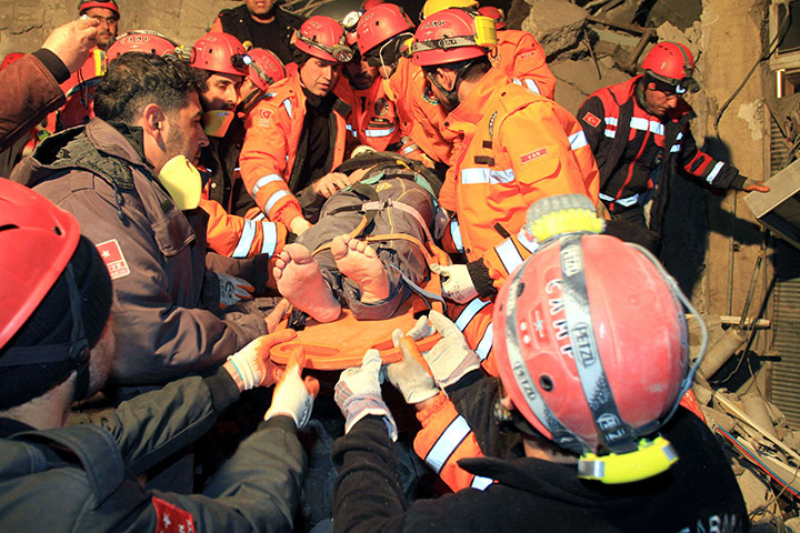 Turkey Earthquake: Rescuers carry a survivor from a collapsed building in Van Turkey