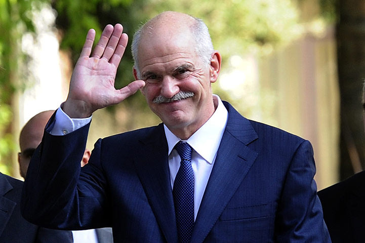 Week in Business: Outgoing Greek Prime Minister George Papandreou waves 