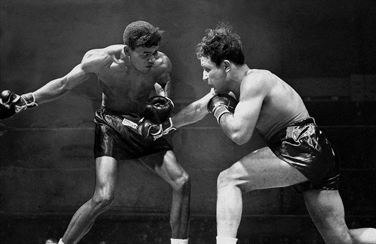 Boxing: In second round at the Garden, Sugar Ray Robinson winds up w