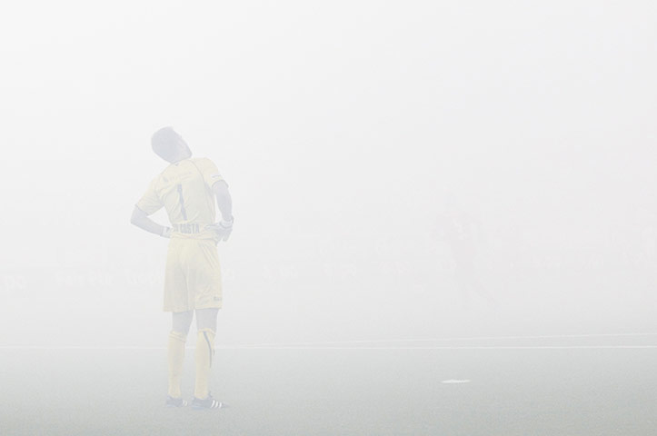 The week in sport: FC Thun's Da Costa is seen in the smoke after FC Luzern fans let off flares