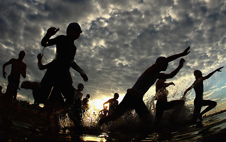 The week in sport: Athletes dive into the water during the Brighton Triathlon in Melbourne