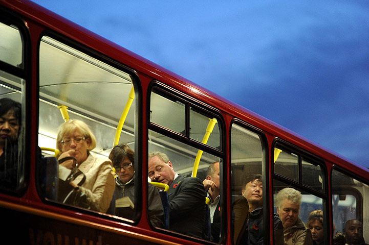 24 hours in pictures: London, UK: Passengers sit on the top deck of a bus