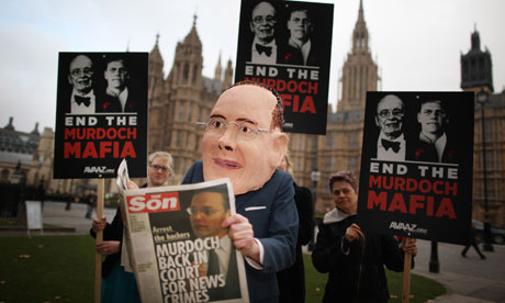 Protester in James Murdoch mask