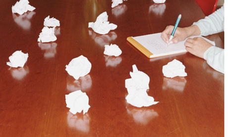 woman writing on notepad