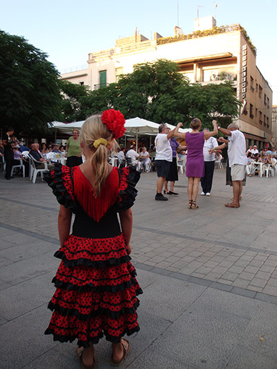 Girl in flamenco dress in Spanish piazza