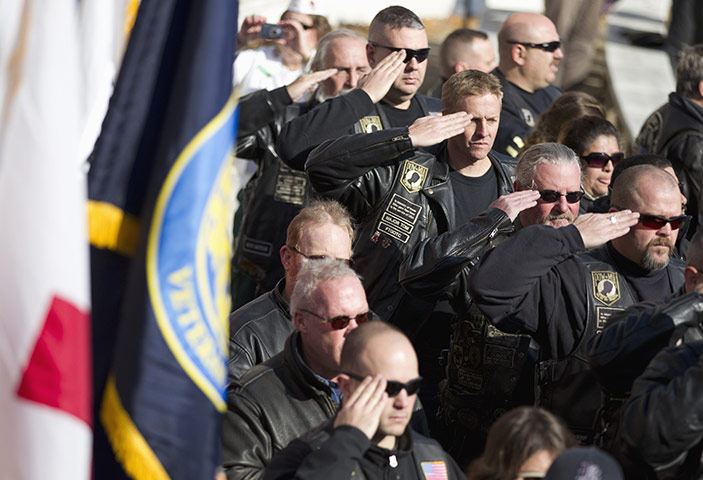 US Remembrance Day: Veterans salute during a ceremony where President Obama spoke Arlington