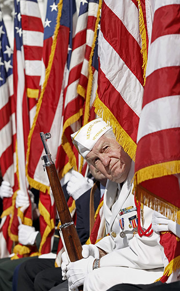 US Remembrance Day: A member of the National Honor Guard listens to President Barack Obama