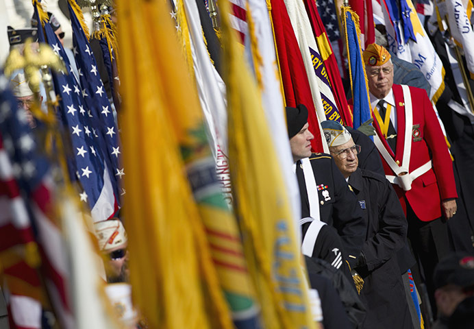 US Remembrance Day: Veterans carry flags during a ceremony where President Barack Obama spoke