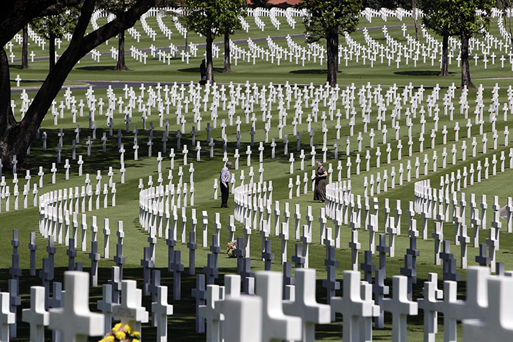 US Remembrance Day: American nationals walk past graves at US Veterans Day rites in Manila