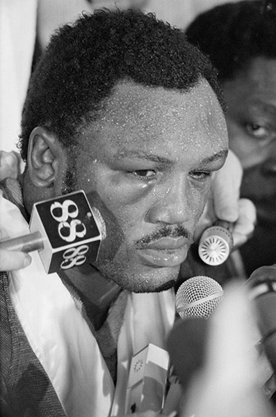 Thrilla in Manila: Puffy-eyed Joe Frazier talks to the press