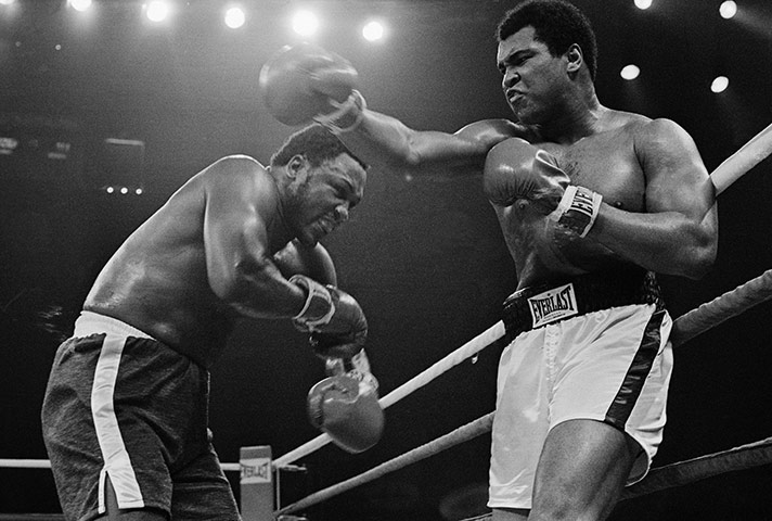 Thrilla in Manila: Ali glances a right off Joe Frazier during the 7th round