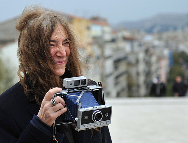 Week in Music: Patti Smith poses with a cintage polaroid camera