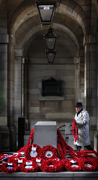 Remembrance Sunday: A man lays a wreath on the Royal Mile in Edinburgh