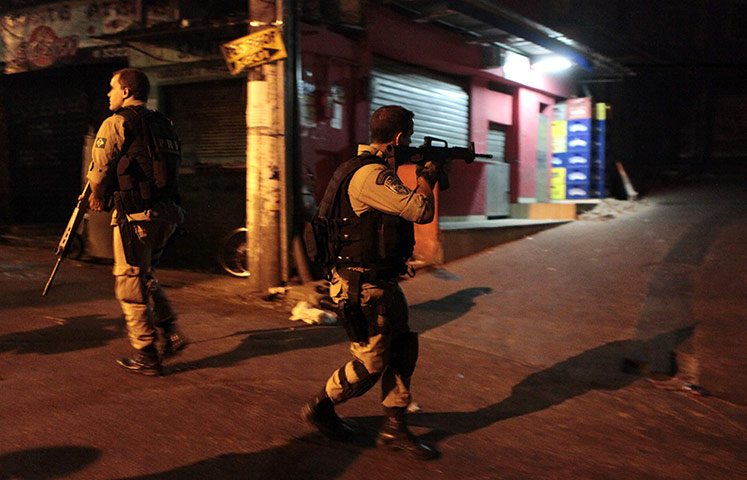 Rio raid: Policemen patrol the Rocinha slum during the Shock of Peace operation