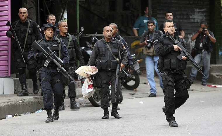 Rio raid: A policeman carries evidence
