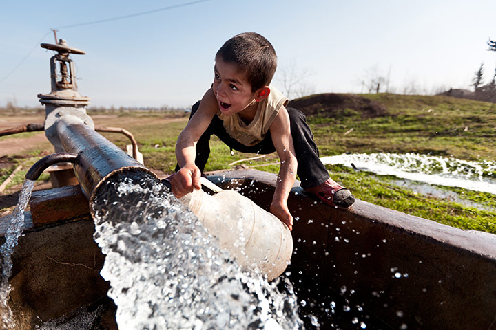 After the thaw: Azerbaijan: A young boy collects water in the Darğalar village of Barda