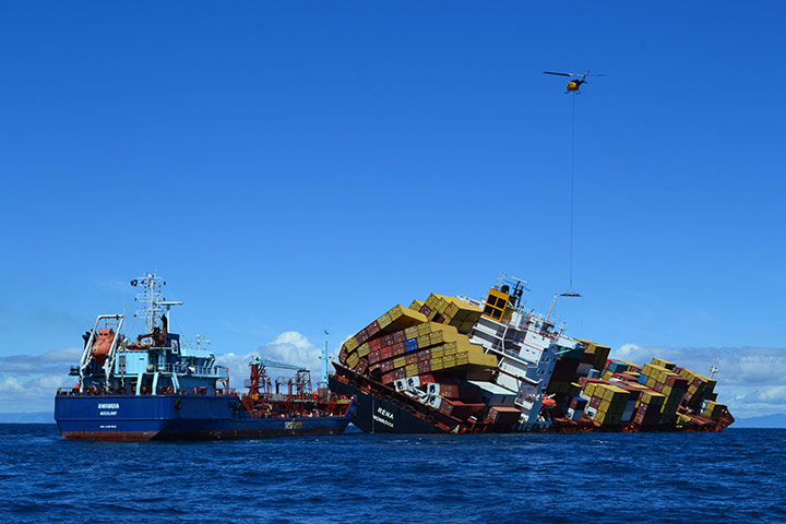 New Zealand oil spill: A tanker pumps the last residual oil out of the containership Rena