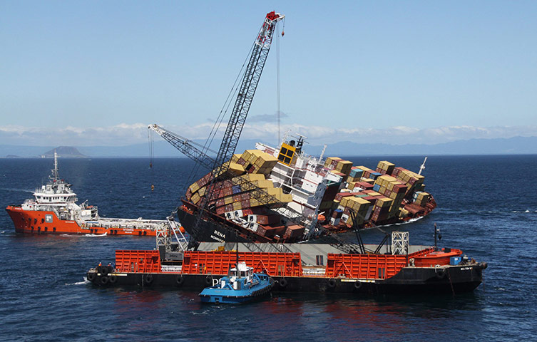 New Zealand oil spill: The container retrieval vessel Sea Tow 60 is positioned next to Rena