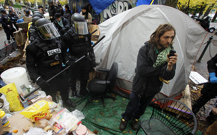 24 hours in pictures: Police officers push people away from the Occupy Portland encampment