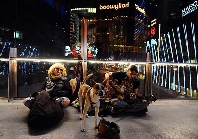 24 hours in pictures: A couple with their dog play music in Las Vegas bridge