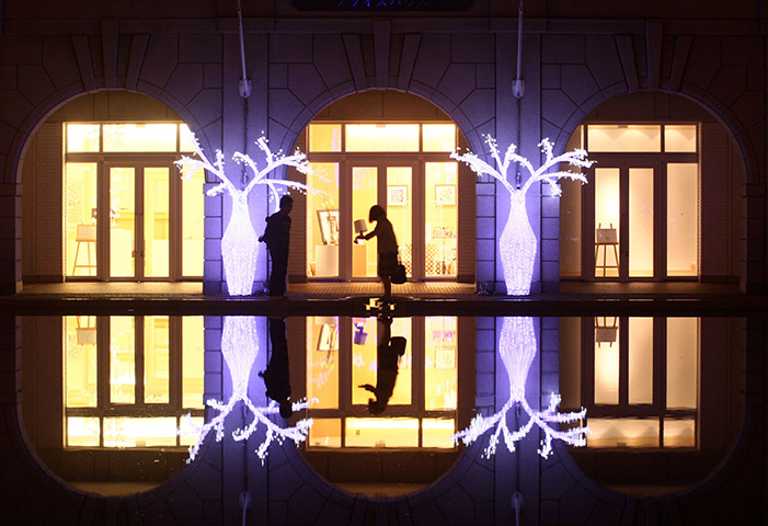 24 hours in pictures: A couple walks through decorations at Kobe Fruits And Flower Park