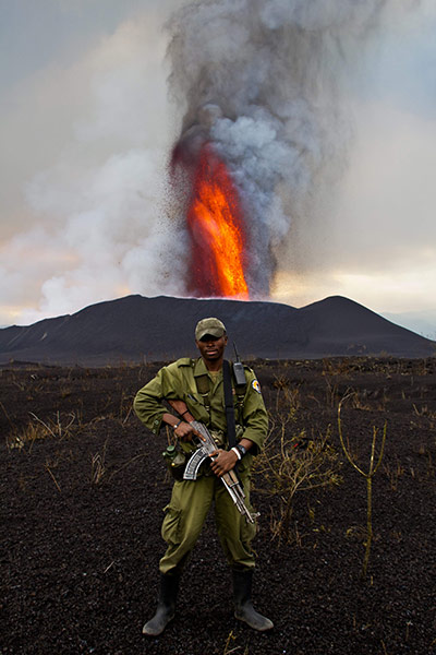 Mount Nyamulagira Congo: A soldier stands guard as the volcano erupts