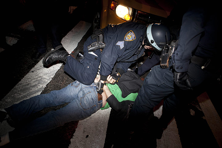 Occupy protest evictions: New York, US: A  protester is detained by police officers