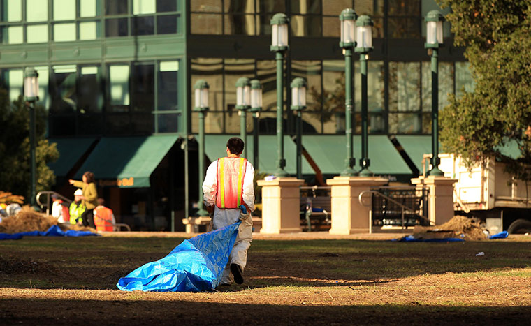 Occupy protest evictions: Oakland, US: A worker walks through Frank Ogawa Plaza