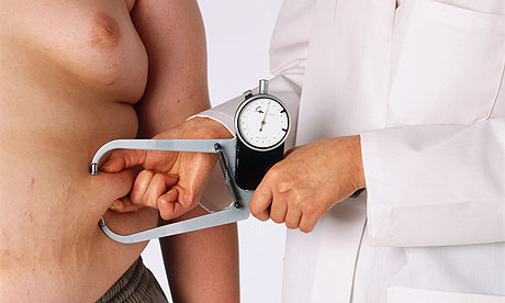 Doctor using calipers to give a skin-fold test