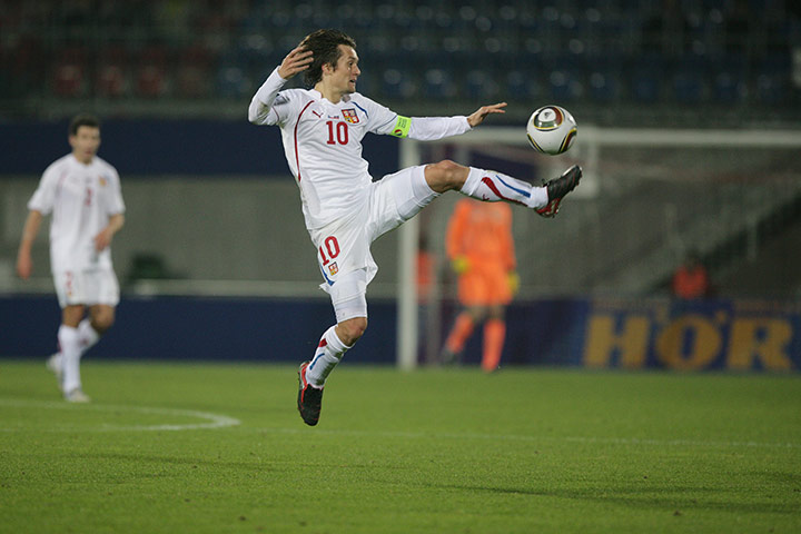 Euro 2012 qualifiers: Czech's captain Tomas Rosicky jumps for the ball