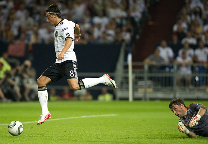 Euro 2012 qualifiers: Germany's Mesut Oezil scores past Austria's goalkeeper Christian Gratzei