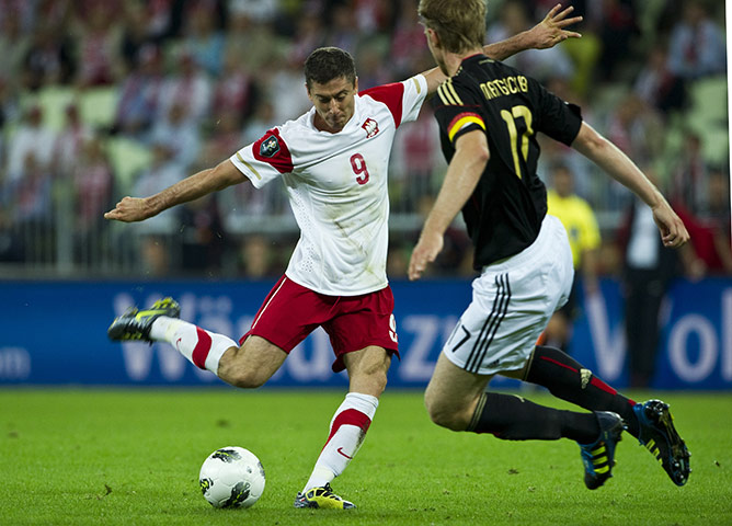 Euro 2012 qualifiers: Germany's Per Mertesacker blocks a shot by Poland's Robert Lewandowski