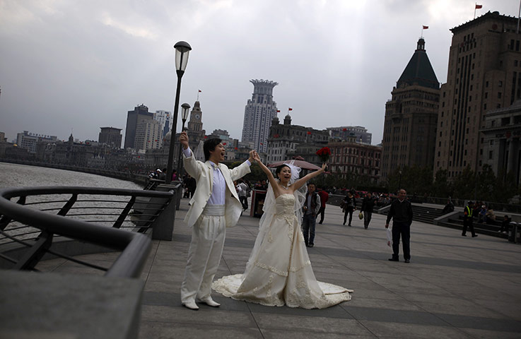 24 hours in pictures: A couple pose for wedding photos on the Bund