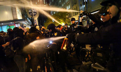 Seattle police officers deploy pepper spray into a crowd during an Occupy Seattle protest.