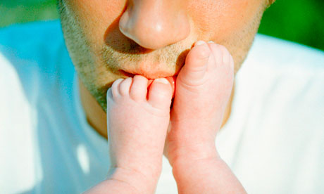 Dad kissing baby's feet