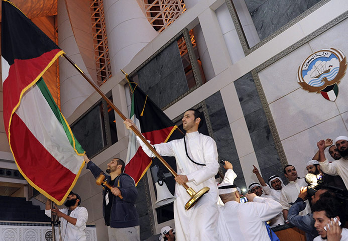 kuwait protests: A protester waves the national flag